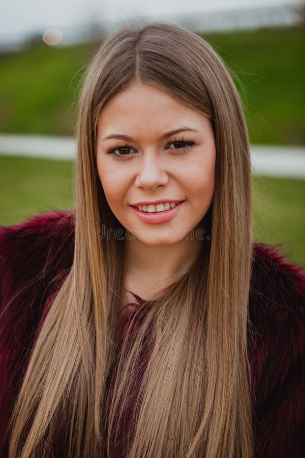 Pretty blonde girl with fur coat. In the park at winter royalty free stock photography Pretty blonde girl with fur coat. In the park at winter royalty free stock photography