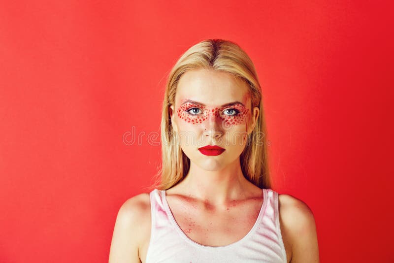 Pretty Blonde Woman With Creative Fashionable Makeup On Red Background