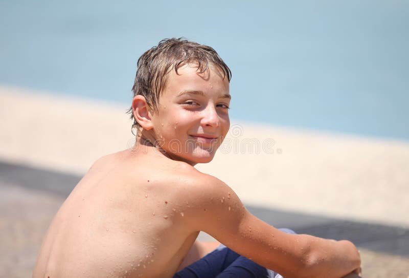 Pretty boy sunbathes on the beach