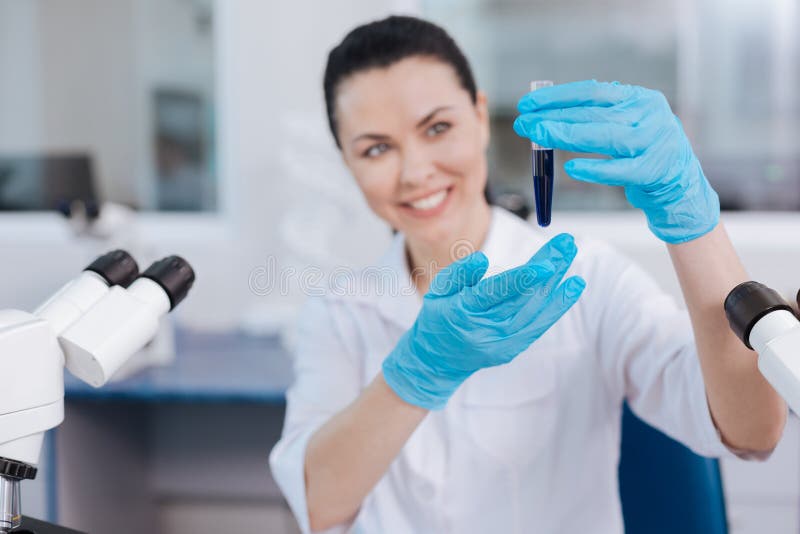 Pretty brunette demonstrating test-tube stock photography Pretty brunette demonstrating test-tube stock photography