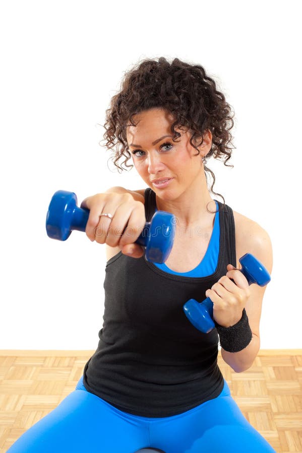 Pretty brunette fitness girl with weights