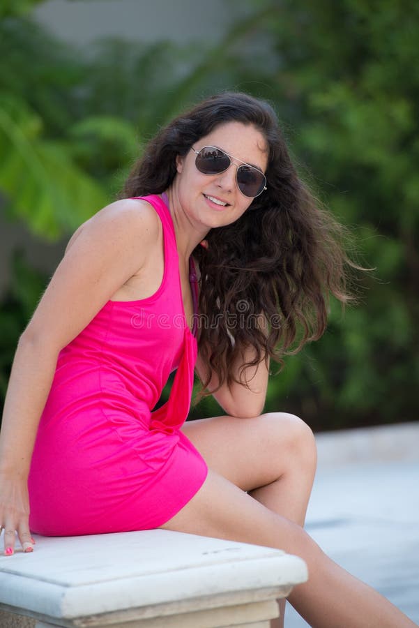 Pretty brunette sitting and smiling