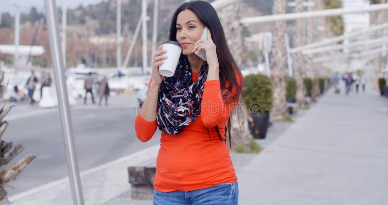 Pretty chic young woman chatting on a mobile