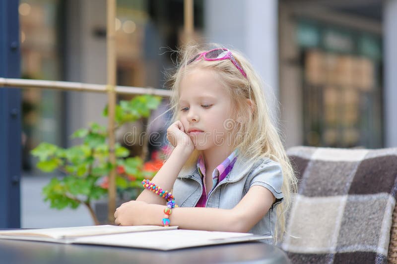 Pretty Child Reading Menu in the Cafe Stock Photo - Image of fashion ...