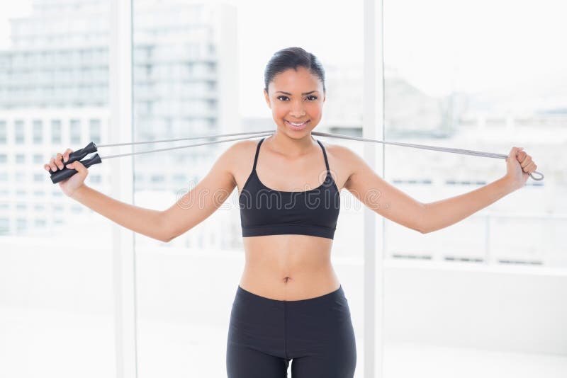 Pretty Dark Haired Model In Sportswear Holding A Skipping Rope Stock Image Image Of Tied