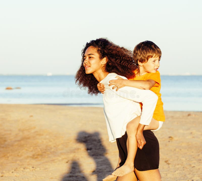 Pretty diverse nation and age friends on sea coast having fun, b