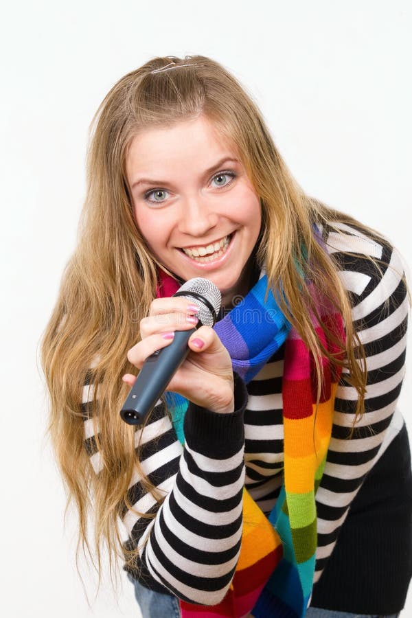 Pretty female with microphone isolated