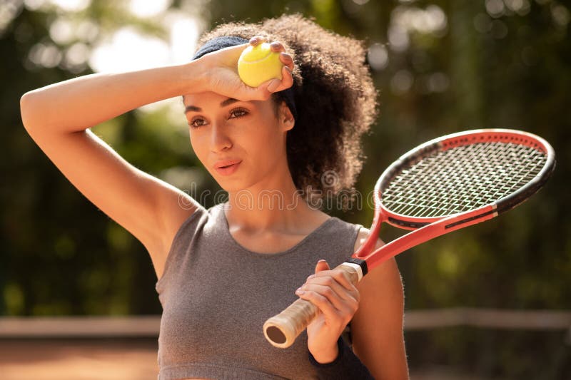 Pretty female tennis layer looking tired after workout royalty free stock photos