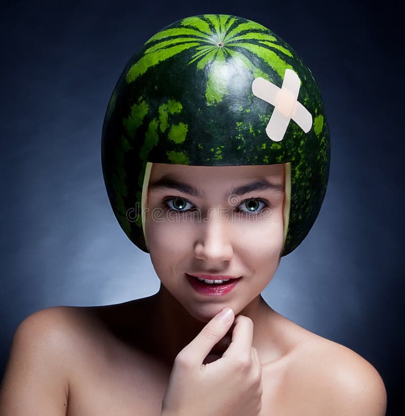 Pretty femalein helmet of ripe watermelon