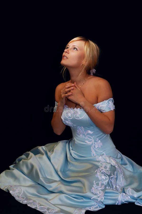 Pretty fiancee in blue dress looking at the sky