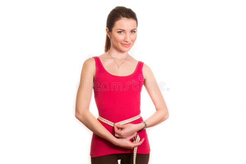 Pretty fitness girl measuring her waist isolated royalty free stock photos Pretty fitness girl measuring her waist isolated royalty free stock photos
