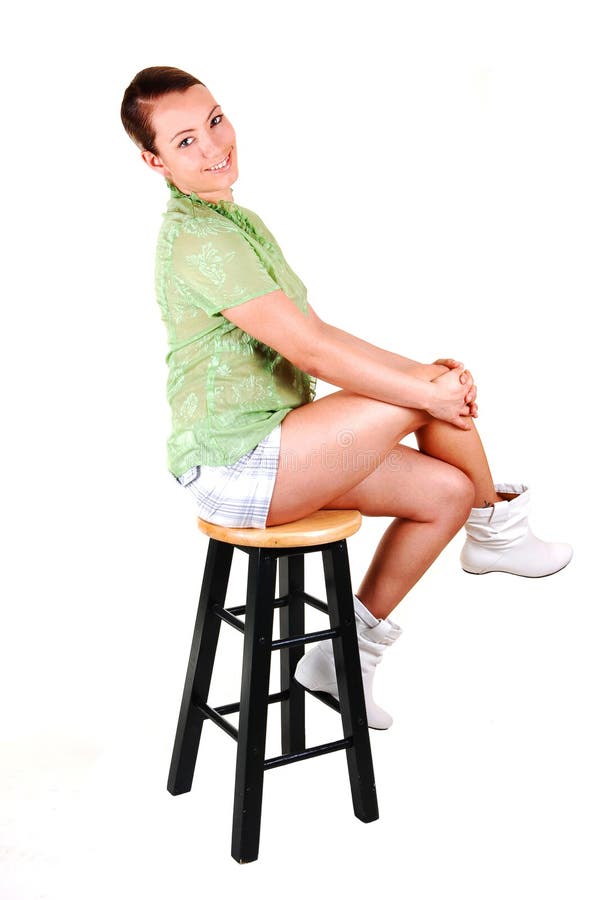 Pretty girl on a bar chair.