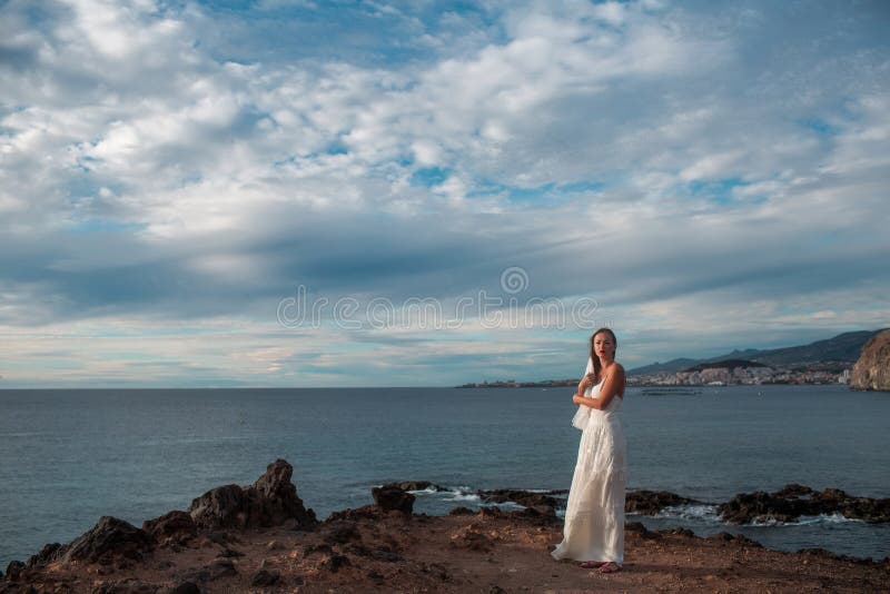 Pretty bride in white wedding dress with veil