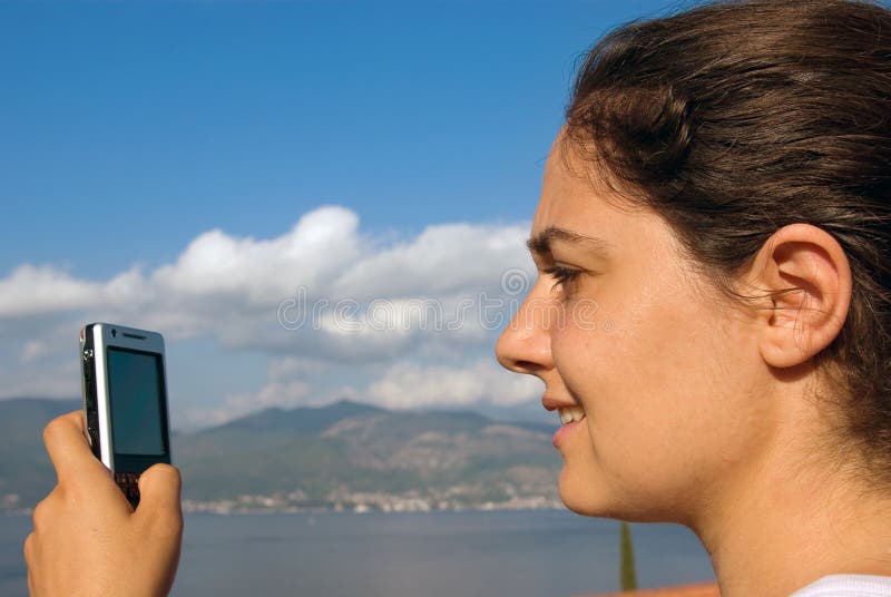 Pretty girl with cellphone at the seaside