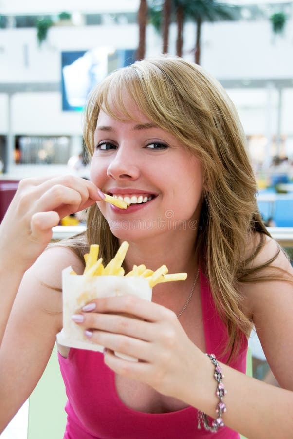 Pretty girl eating french-fries