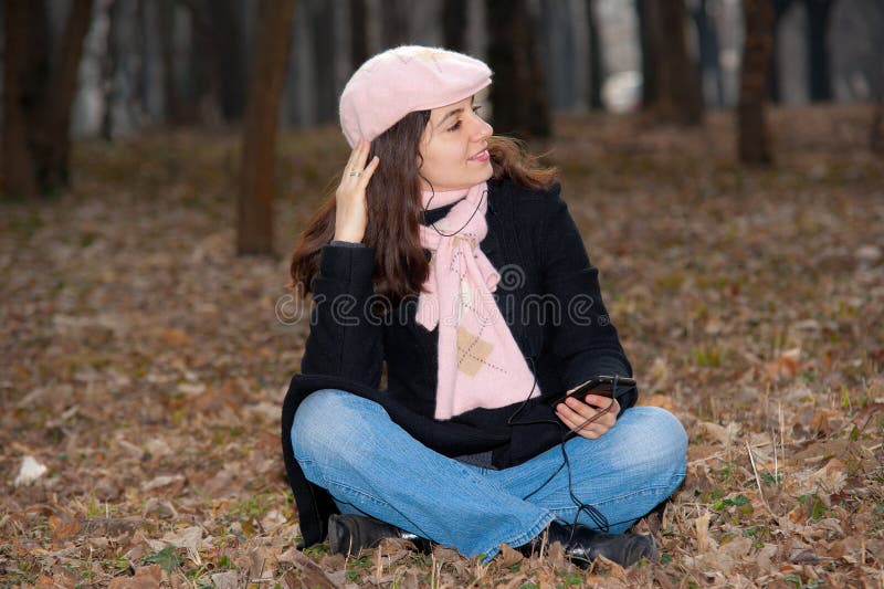 Pretty girl enjoying music outdoors