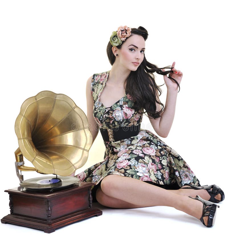 Pretty girl listening music on old gramophone