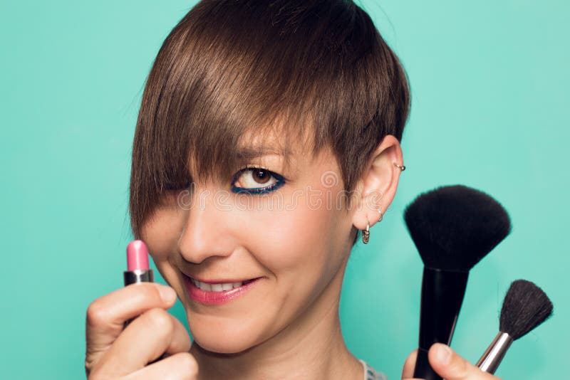 Pretty girl with makeup and makeup accessories. Lipstick, makeup applicator stock image Pretty girl with makeup and makeup accessories. Lipstick, makeup applicator stock image