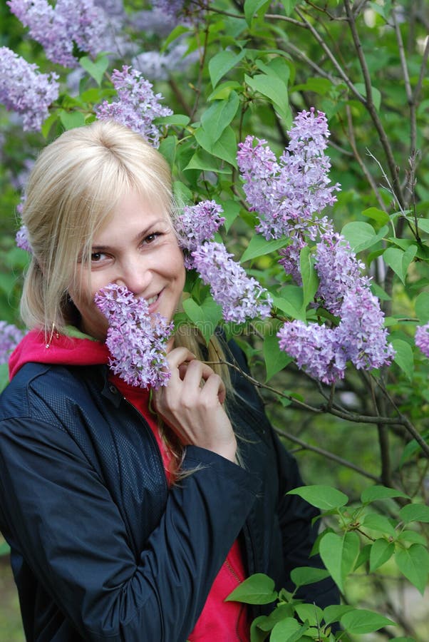The pretty girl near a bush of a lilac royalty free stock photography The pretty girl near a bush of a lilac royalty free stock photography