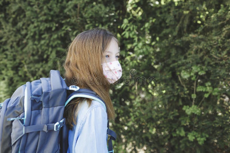 Pretty girl with nose mouth mask and school bag goes to school after corona quarantine royalty free stock image Pretty girl with nose mouth mask and school bag goes to school after corona quarantine royalty free stock image