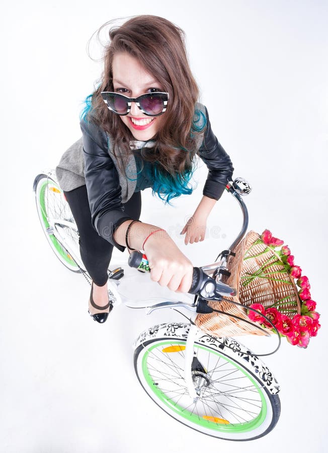 Pretty girl riding a bike smiling - on white background stock photography Pretty girl riding a bike smiling - on white background stock photography