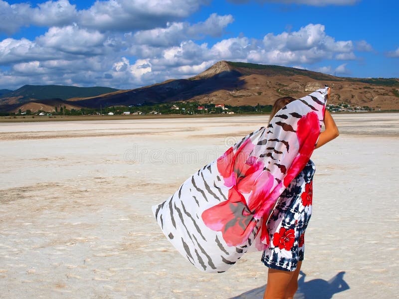 Pretty girl with sarong on a salt lake