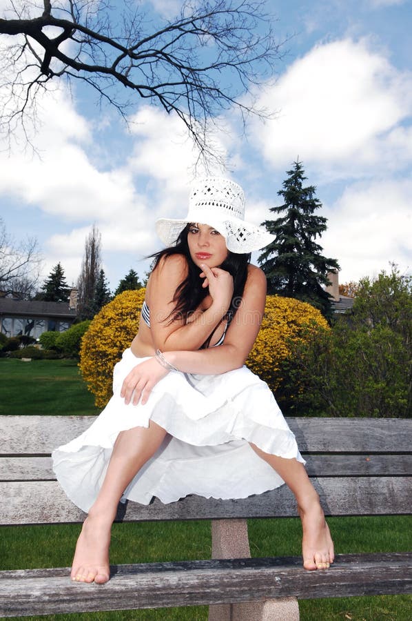 Pretty girl sitting on the bench.