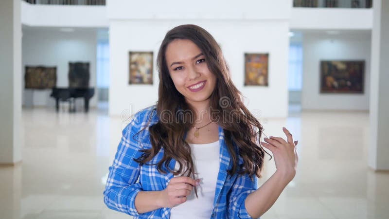 Pretty girl smiling and touching her hair.