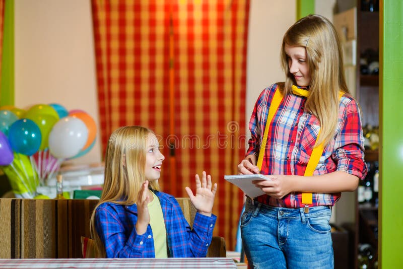 Pretty girl smiling waiter takes the order from