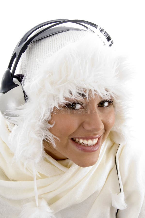 Pretty girl wearing winter clothes and listening