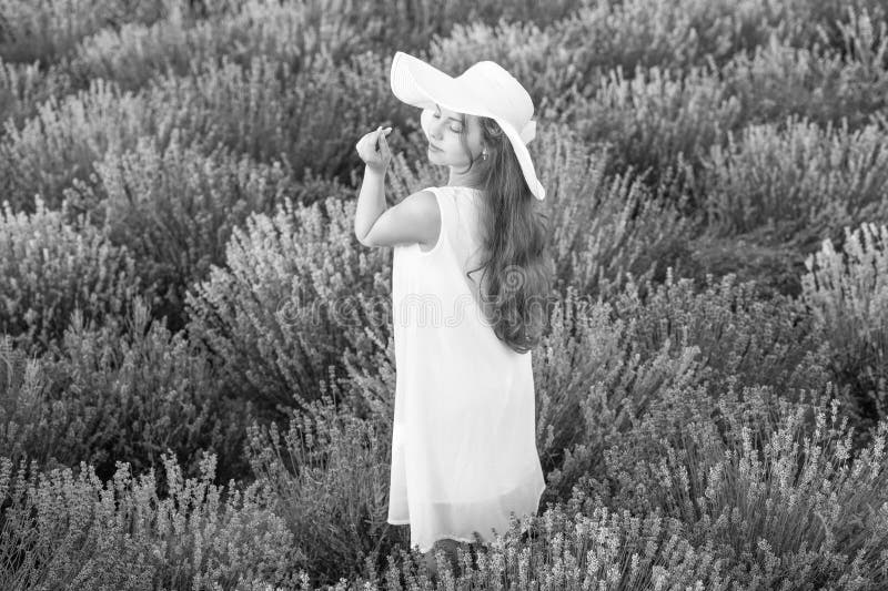 Pretty girl in white dress walking through lavender flowers. lovely girl posing in lavender flowers. beautiful girl in royalty free stock images