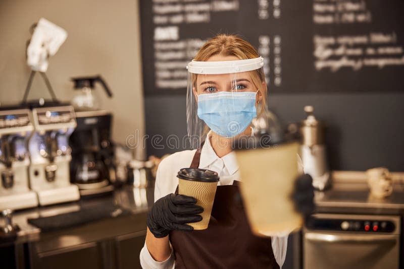 Pretty lady in the cafe offering you hot beverage