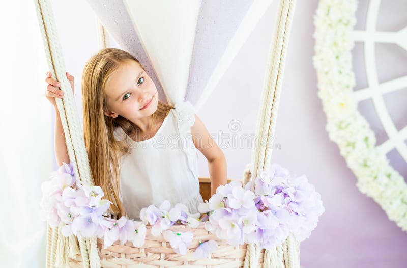 Pretty little blond girl standing in the beautiful decorative air balloon