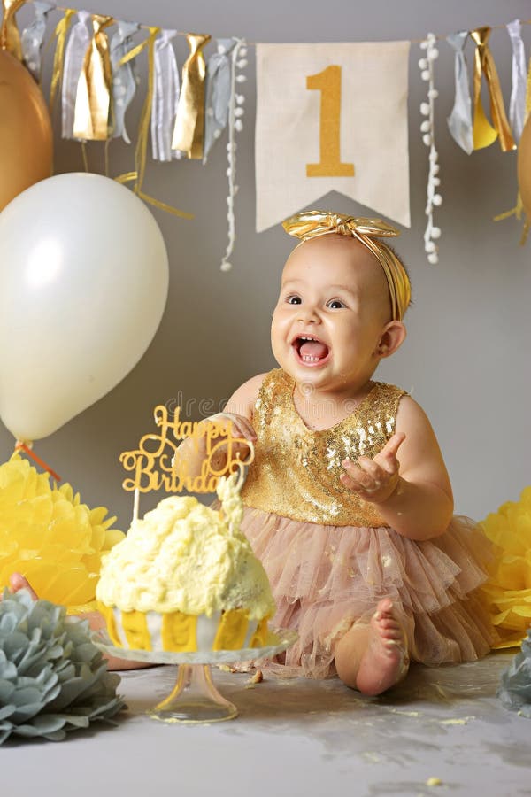 Pretty little girl with birthday cake. Cute baby on her birthday party. Cake Smash stock images Pretty little girl with birthday cake. Cute baby on her birthday party. Cake Smash stock images
