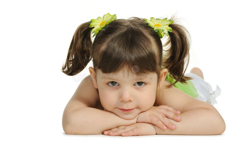 Pretty the little girl lies on the white stock photos Pretty the little girl lies on the white stock photos