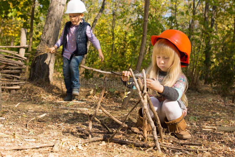 Pretty little girl playing at being a builder