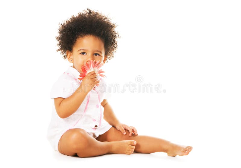 Pretty little girl smelling a flower royalty free stock photography Pretty little girl smelling a flower royalty free stock photography