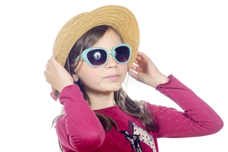 A pretty little girl with sunglasses and straw hat