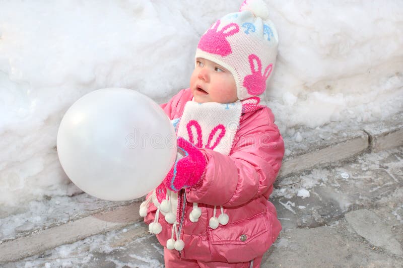 Pretty little girl with white balloon.