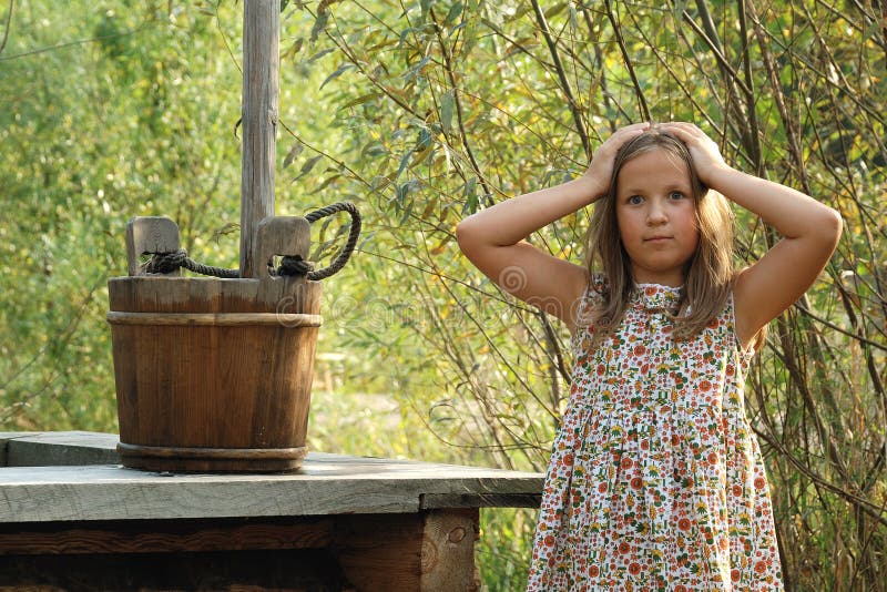 Pretty little girl with wooden bucket