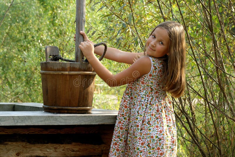 Pretty little girl with wooden bucket