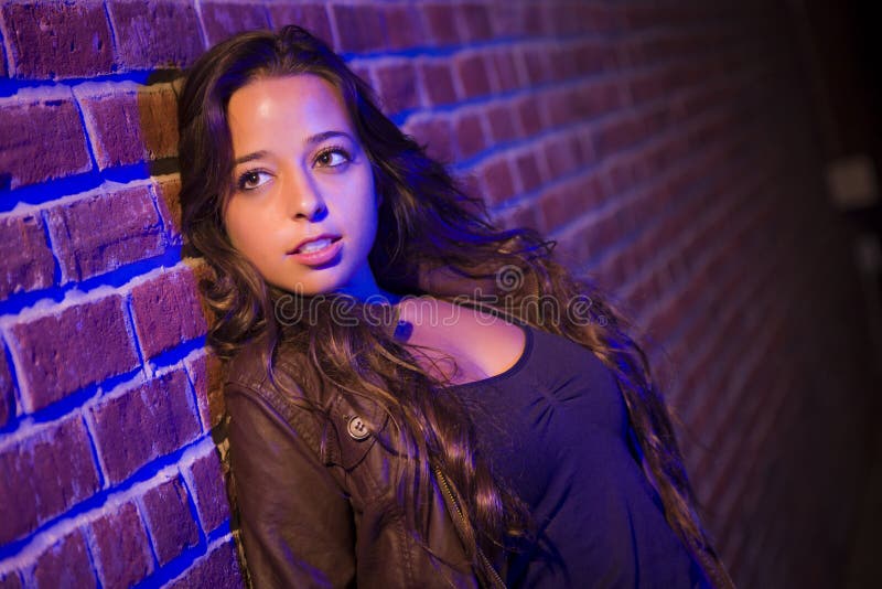 Pretty Mixed Race Young Adult Woman Against a Brick Wall royalty free stock photos Pretty Mixed Race Young Adult Woman Against a Brick Wall royalty free stock photos