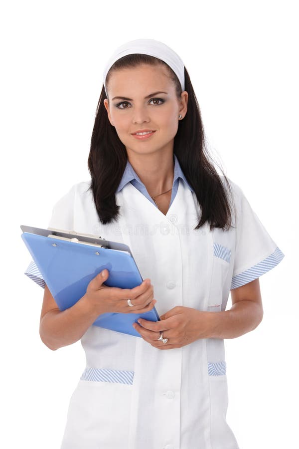 Pretty young nurse with papers in hands, smiling. Standing file folder stock images, royalty-free photos and pictures