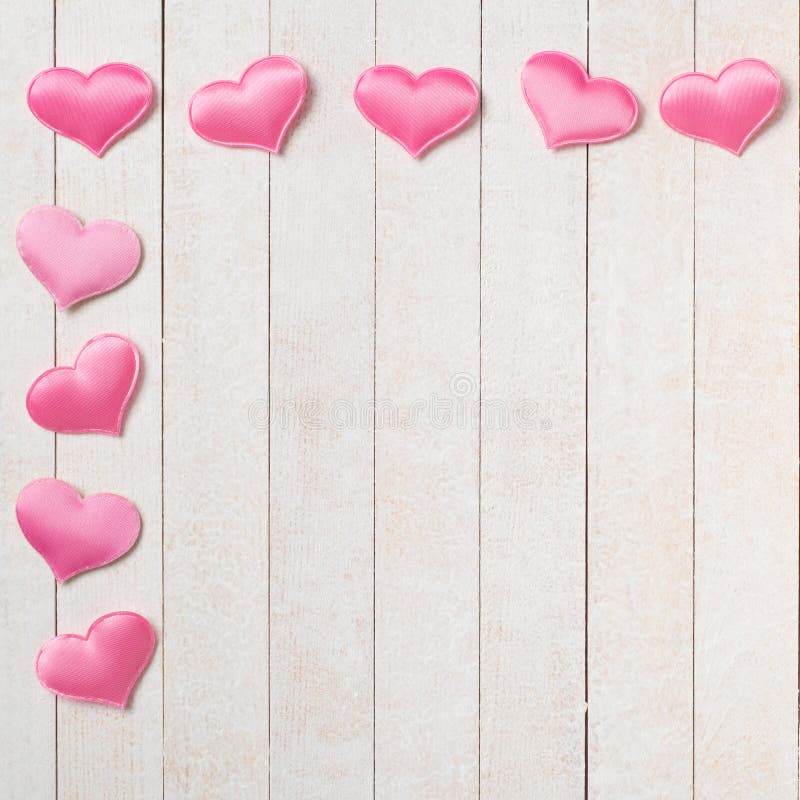 Pretty Pink Valentines Day hearts on White wood Boards Background with a Shabby Chic Style.  It`s a square with copy space in the