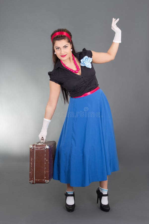 Pretty pinup girl with retro suitcase stock images Pretty pinup girl with retro suitcase stock images