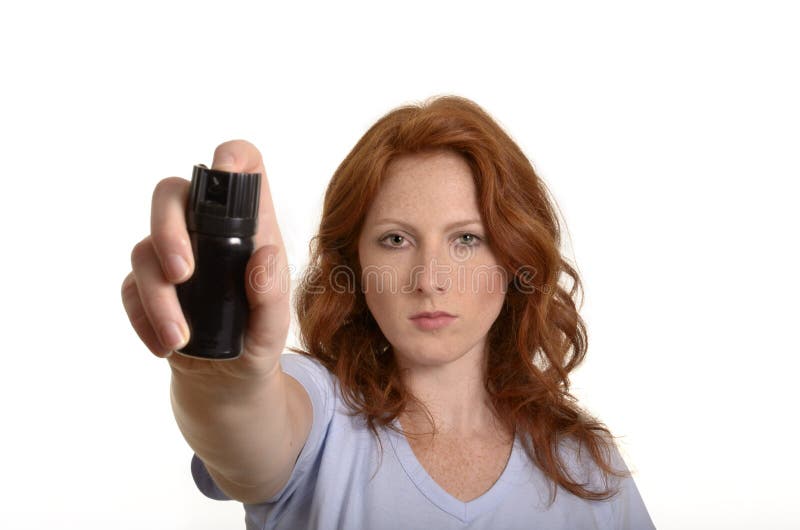 Pretty red-haired woman with pepper spray