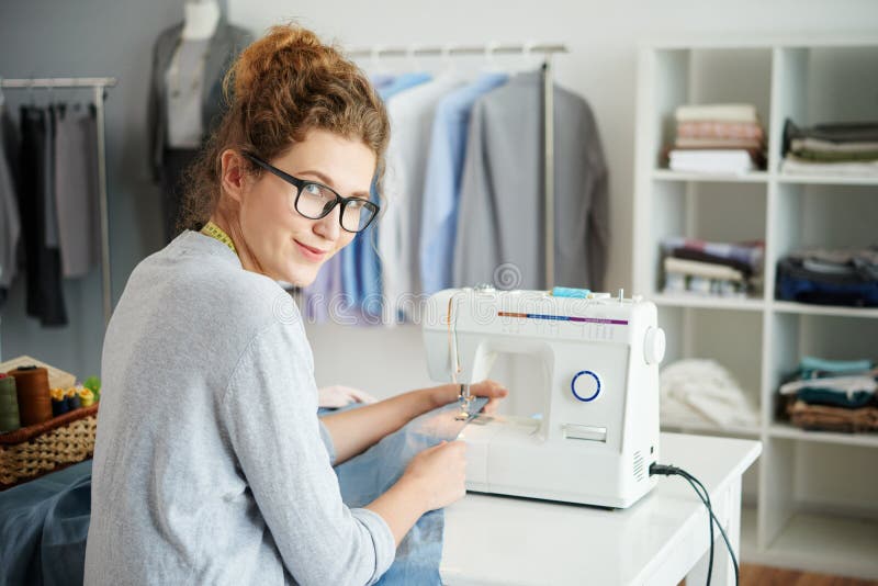 Pretty Seamstress Scissors in Hand is Against the Background of the