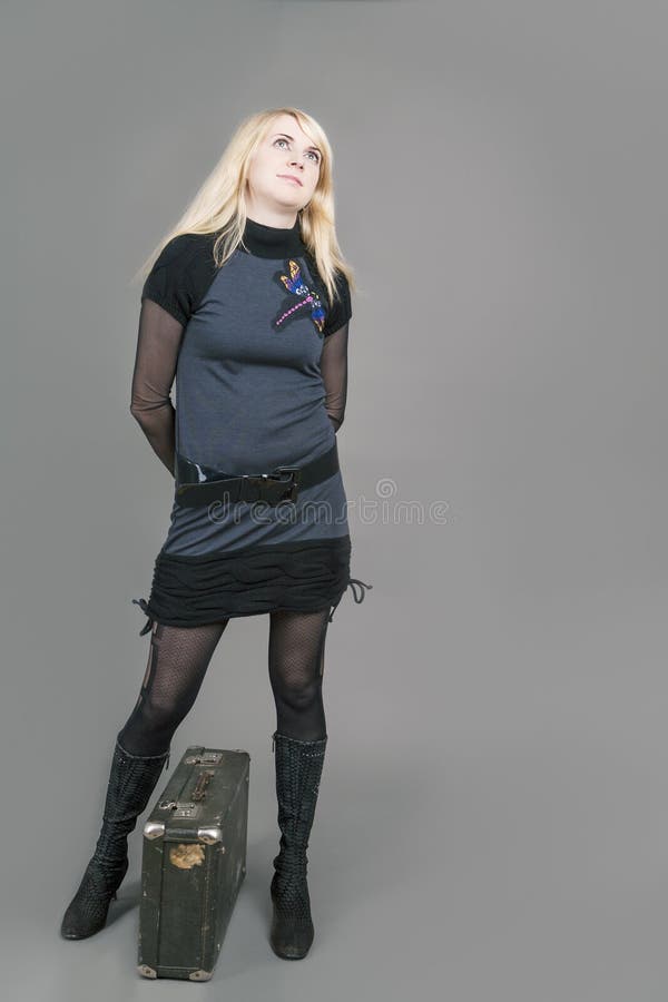 Pretty Sensual Caucasian Blond Female Posing with Suitcase. Against Gray stock images Pretty Sensual Caucasian Blond Female Posing with Suitcase. Against Gray stock images