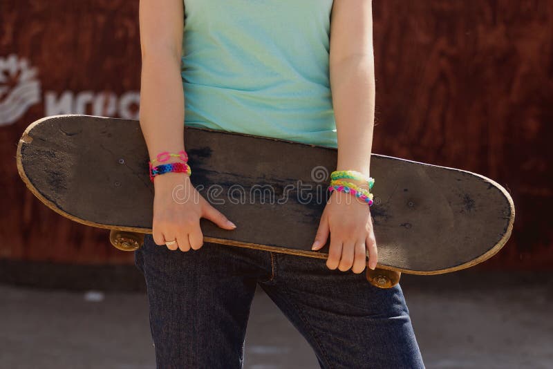 Pretty skater girl holding skateboard royalty free stock photography Pretty skater girl holding skateboard royalty free stock photography
