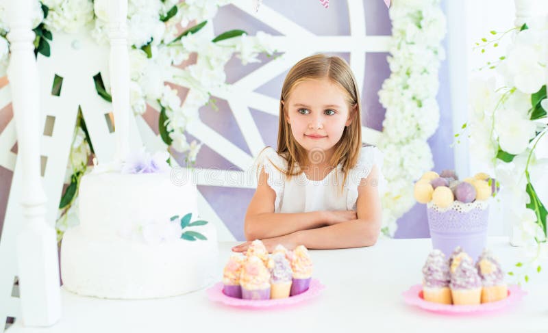 Pretty smiling little girl in the candy bar